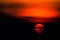 Setting sun sunset colors wave in red orange contrast dark black sky nature amazing background