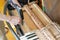 Setting up an old piano. The master repairs an old piano. Deep cleaning the piano. Hands of professional worker repairing and