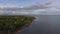 Settlement houses and establishments along tropical sandy Beach and Beautiful Calm Sea On Cloudy Day