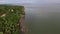 Settlement houses and establishments along tropical sandy Beach and Beautiful Calm Sea On Cloudy Day