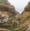 Settlement in the rocky coast of Santo Antao island. Houses nestle into the sides of bluff ridge. Fontaihas village