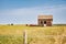 A settlers cabin in a pasture