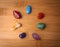 Seven Chakra gemstones in a wood surface