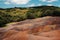 Seven colored earths in Mauritius, nature reserve, Chamarel. The green forest is behind us.Mauritius island