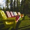 Seven Colorful Adirondack chairs in the sun