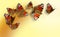 Seven colorful butterflies on yellow-orange background