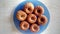 Seven fresh gingerbread muffins on a blue flat plate