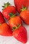 Seven in a heart Shape  Healthy Scottish Strawberries on a White Plank Board