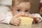 Seven-month baby eats a big piece of cheese