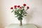 Seven red roses in a vase. Romantic background, Valentines day concept. Design for greeting card, calendar, poster.