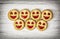 Seven round biscuits smiling faces, humorous food theme