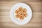 Seven round biscuits smiling faces on the white plate, humorous