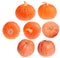 Seven small orange pumpkins on white