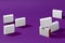 Seven small white carton boxes or packs with colorful sides and no logo against purple studio background. Close up, copy