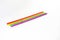 Seven straws of rainbow colors lie on a white background. Bright colors. The colors symbolize the concept of unification