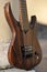 Seven-string electric guitar made of dark wood. Background for music and creativity