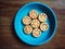 Seven sweet homemade cookies on a blue plate