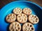 Seven sweet homemade cookies on a blue plate