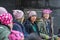 Seven woman wearing hats.