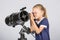 Seven-year girl in glasses with interest looks in a reflector telescope