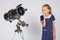 Seven-year girl with interest looking at a reflector telescope