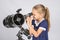 Seven-year girl squinting with interest looks in a reflector telescope