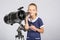 Seven-year girl standing next to reflector telescope and looks mysteriously into the sky