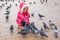 Seven-year girl in wiinter feeding pigeons in the street