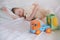 Seven-year-old boy sleeping with his toys bear and plastic car. Focus on toy car.