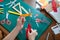 A seven-year-old girl cuts out with a scissors yellow paper.