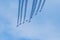 several airplanes fly through the air leaving trails in formation,