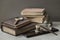 Several of antic books, set of old stationery, wooden pen, inkwell, magnifier close-up, vintage background. Concept of