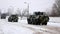 Several armored vehicles carriers drive along a snow-covered road. Russo-Ukrainian War