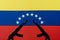 Several automatic rifles raised up on the background of the Venezuelan flag