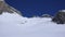 Several backcountry skiers enjoy a ski descent down a remote moutain peak in Switzerland on a beautiful winter day