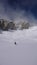 Several backcountry skiers enjoy a ski descent down a remote moutain peak in Switzerland on a beautiful winter day