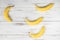 Several bananas on a wooden background. Ordinary bananas with spots