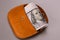 Several banknotes cute looks out of brown leather retro purse