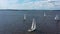 Several beautiful white yachts sailing across the beautiful pond. Video. Aerial view of small sailing boats on the river