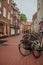 Several bikes stopped at the alley entrance in the City Center of s-Hertogenbosch.
