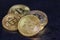 Several Bitcoin coins on a dark background