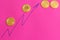 Several bitcoin coins on pink background - image