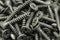 Several black anodized screws background