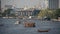 Several boats travelling in busy Bangkok river