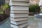 Several books as a stack on a glass table