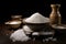 Several bowls of different types of salt on a wooden table