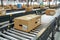 Several boxes on conveyor belt depict efficient logistics operations