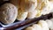 Several Brazilian cheese breads smoking, through a showcase of a Brazilian bakery_vertical