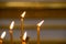 Several burning church candles, soft focus