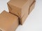 several cardboard boxes. Cardboard Boxes Stacked Against White Background